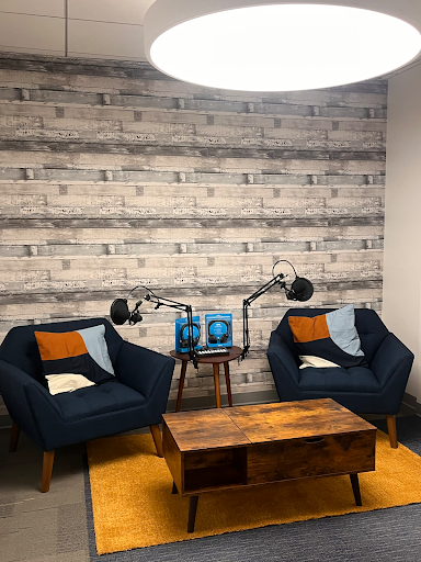 Media studio with microphones and two chairs for podcast, reels, and other media-related recordings.