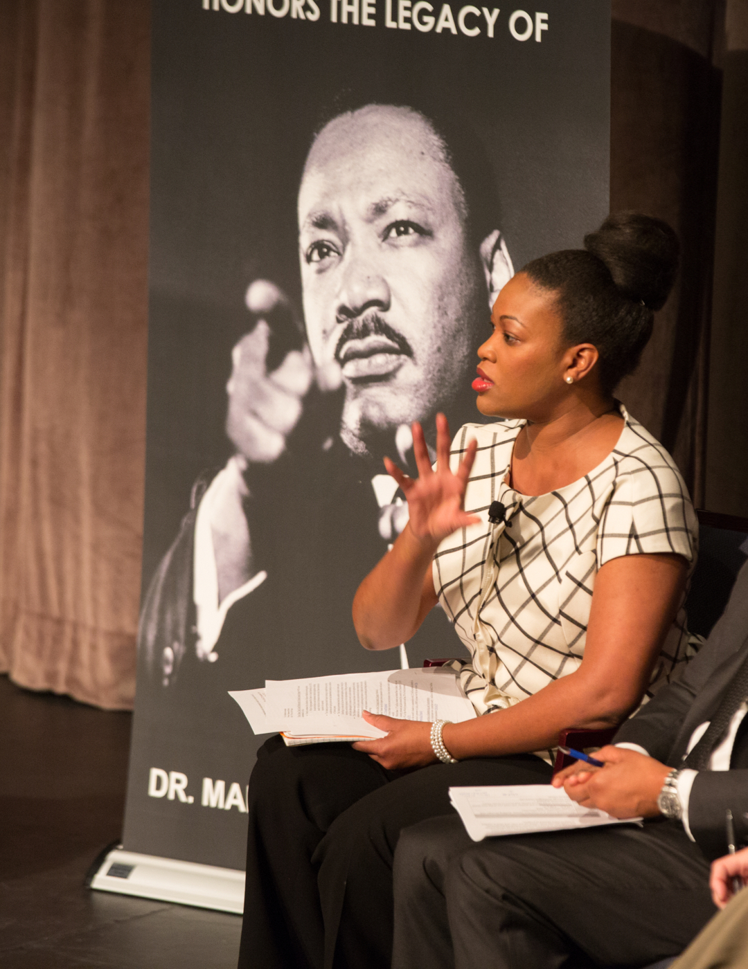 Speaker in front of MLK sign