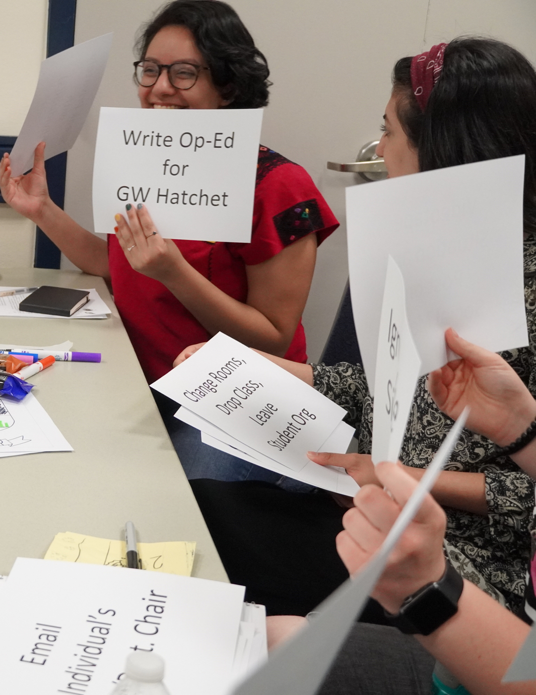 Students holding papers