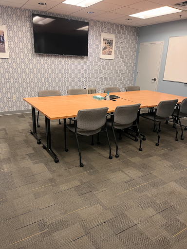 Large Conference Room with white board and TV. Seats 8